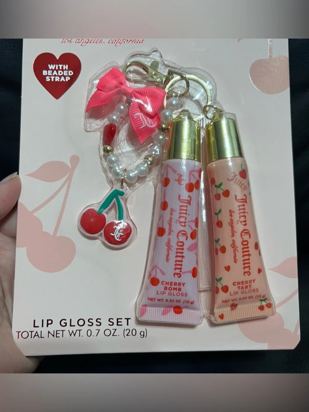 Juicy Couture lip gloss set that includes a beaded cherry keychain